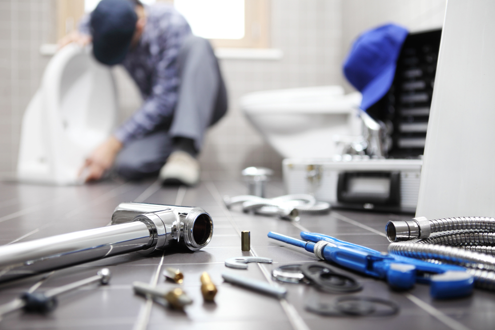 Plumber,at,work,in,a,bathroom,,plumbing,repair,service,,assemble