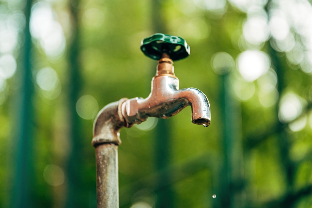 Water,supply,,outdoor,garden,faucet,with,green,handle,and,water